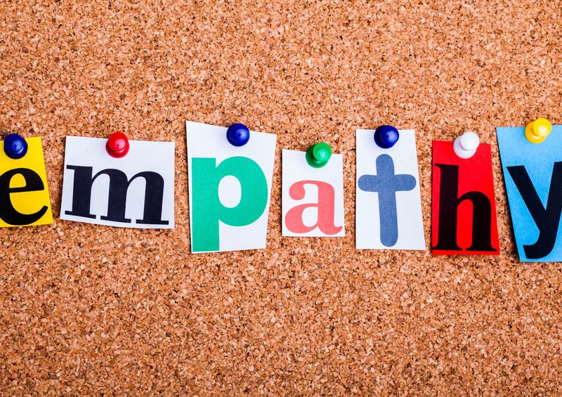 The Word Empathy In Cut Out Magazine Letters Pinned To A Cork No